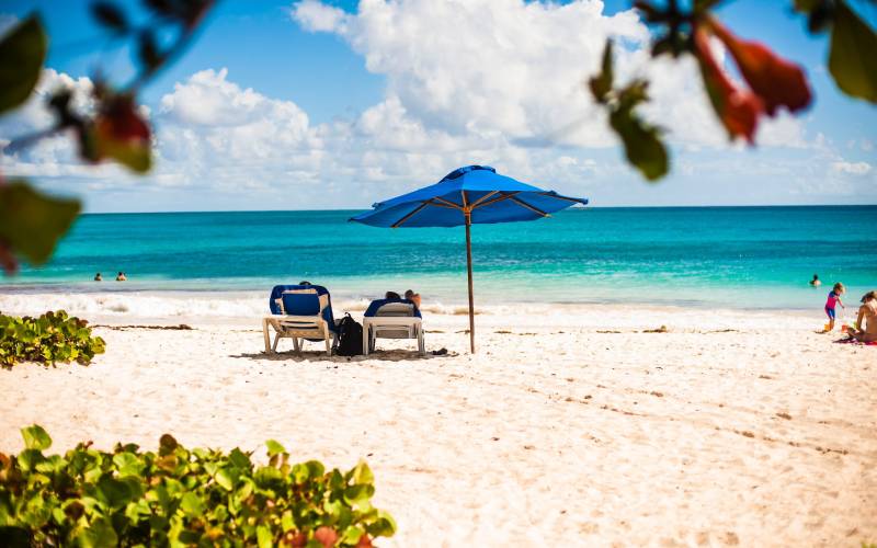 couple sitting along a beach at Barbados