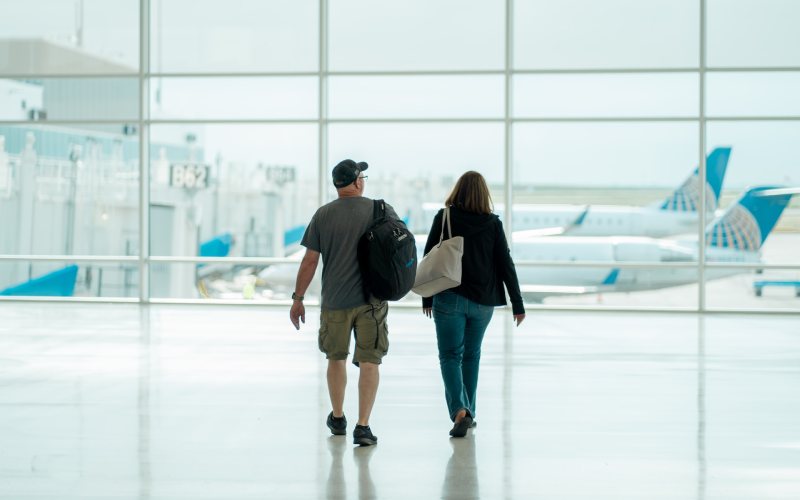 Travellers at airport with bagpack