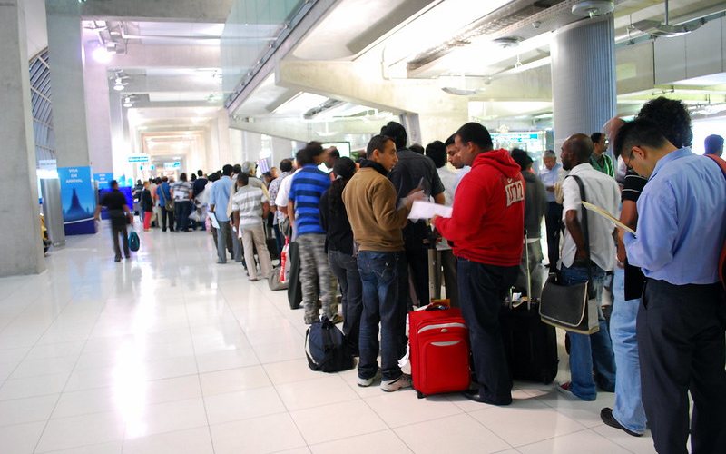 People standing in a line for transit visa