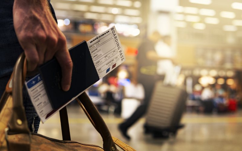 A man holding passport at the airport .