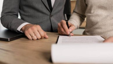 A man signing visa documents.